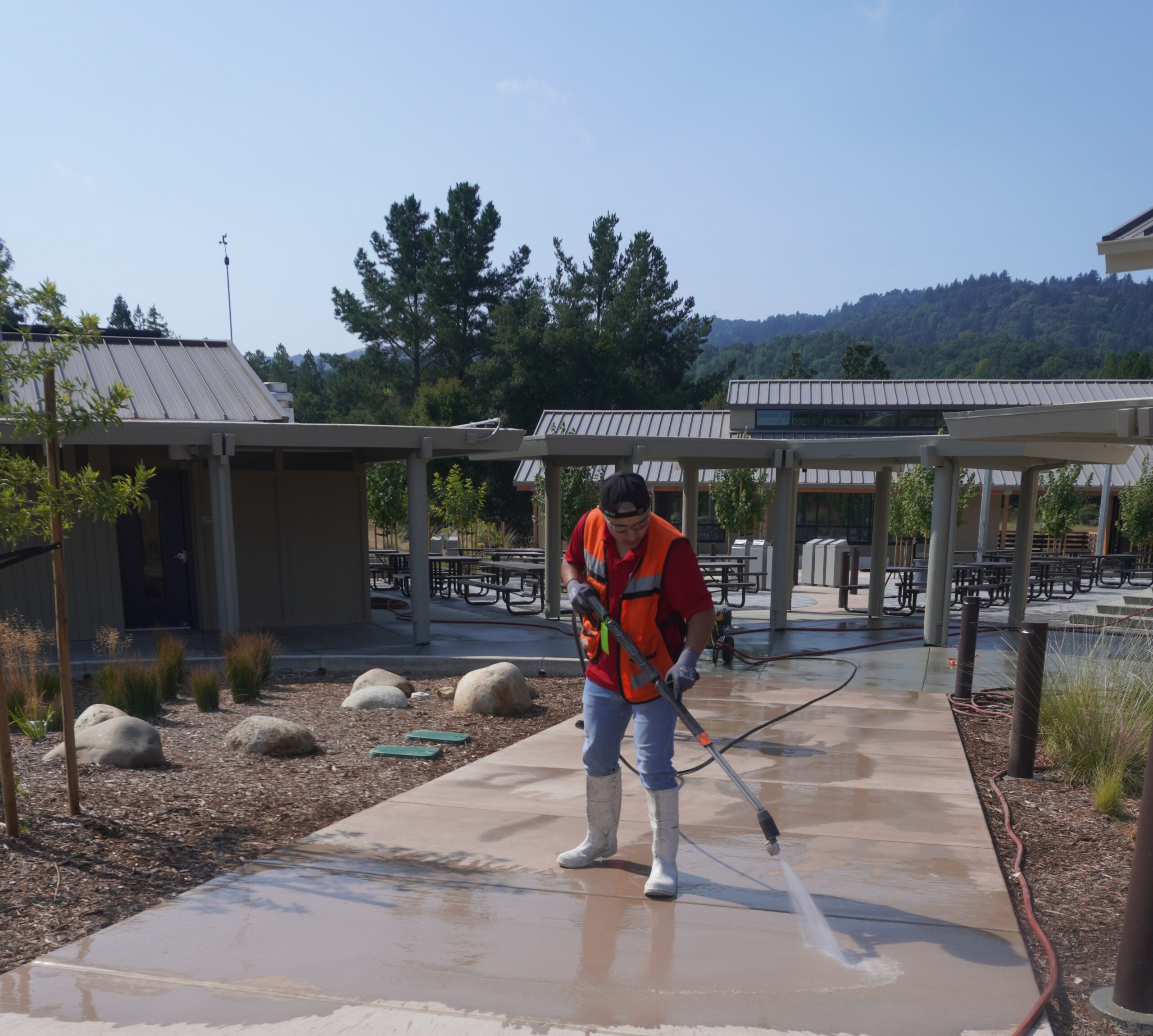 A man power washing the ground